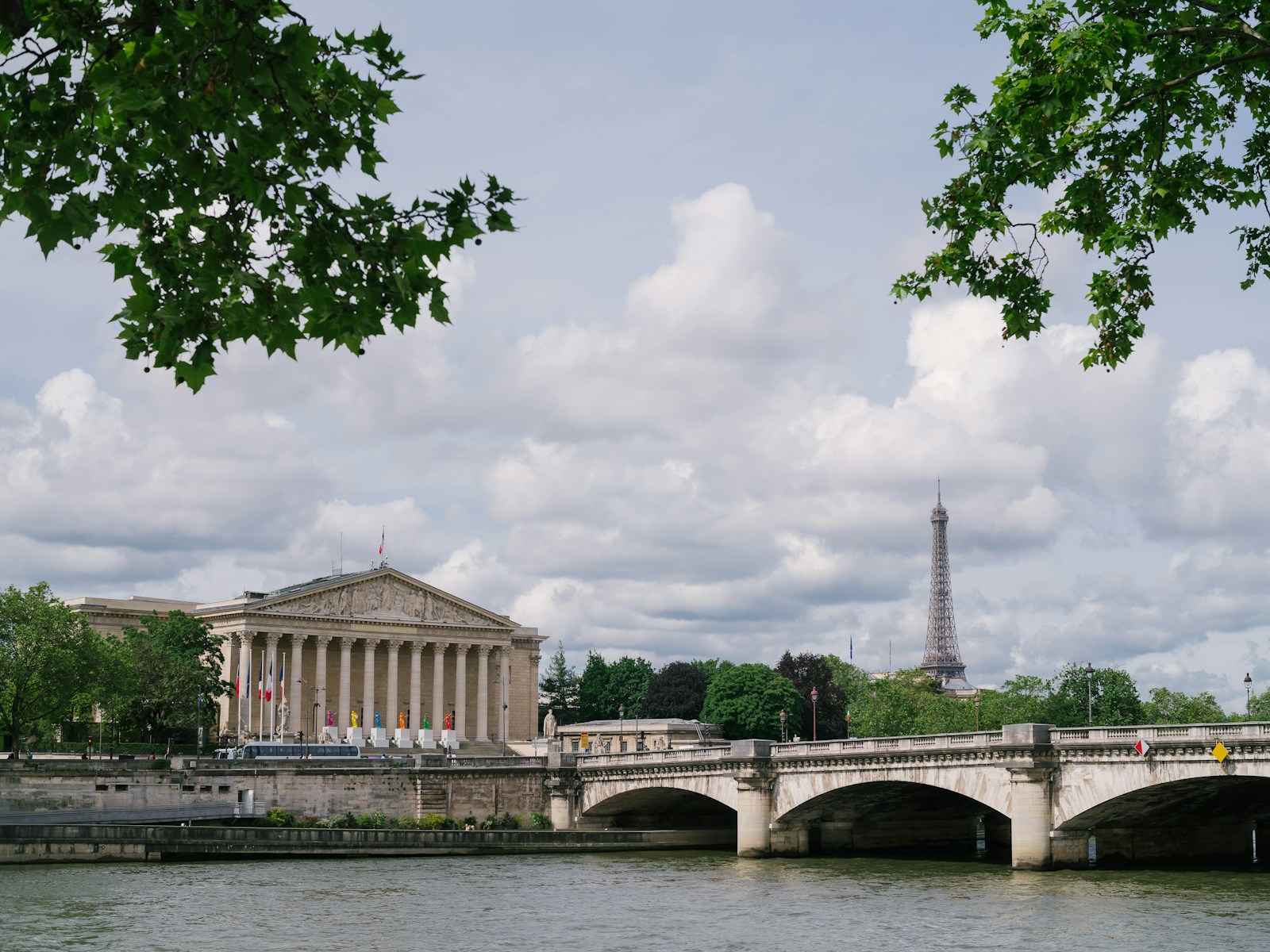 a bridge over a body of water with a building in the background